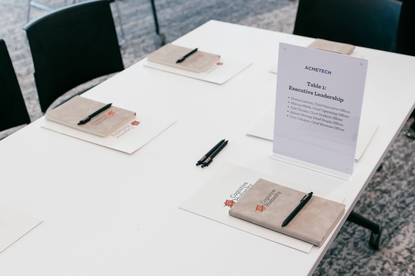 A workshop table set with Cognitive Humanity notebooks